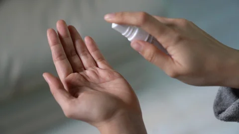 Washing hand by using alcohol spray to prevent coronavirus Stockbeeldmateriaal 128222277