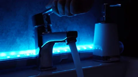 Washing hands in blue light Stock Footage 137743423