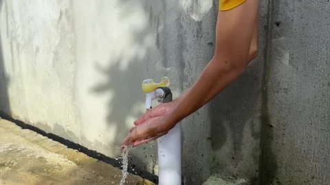 Washing hands with clean running water from a tap Stock Footage 295941453