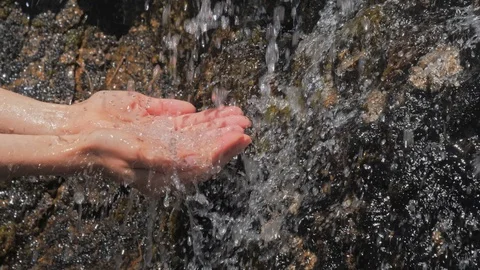 Washing hands in fresh, cold source water on a mountain, Natural Spring Water Stock Footage 111605745