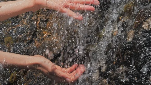 Washing hands in fresh, cold source water on a mountain, Drinking Spring Stock Footage 111608841