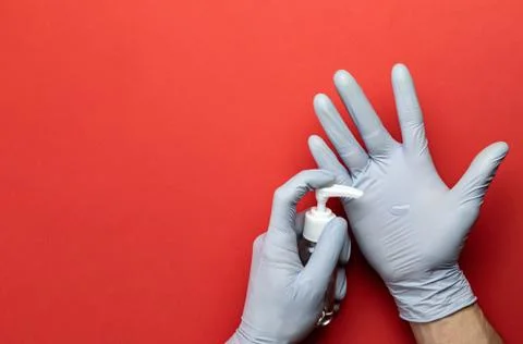 Washing hands isolated on red. Using medical sanitizer gel in lab gloves on r Stock Photos