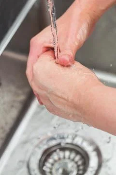 Washing hands in the kitchen Фото