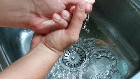 Washing hands at the kitchen sink Stock Footage 108965317