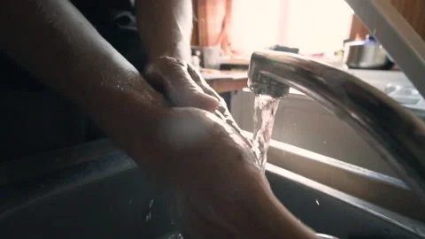Washing hands in kitchen sink Video stock 132733758
