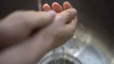 Washing Hands In Kitchen Sink with Hand Soap Video stock 127785264