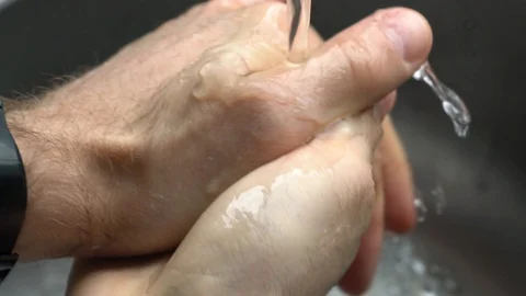 Washing Hands In Kitchen Sink with Liquid Hand Soap Video stock 127785205