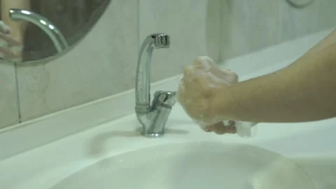 Washing-hands-with-soap-lather-bathroom-sink Stock Footage 344800044