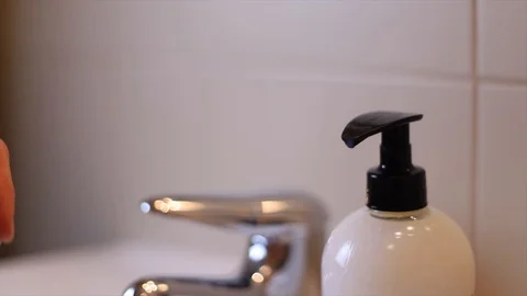 Washing hands to spread viruses Stock Footage 128984859