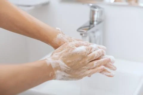 Washing hands under the flowing water tap. Hygiene concept hand detail. Washing Stock Photos