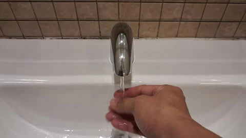 Washing Hands Under Running Chrome Faucet in Bathroom Sink Stock Footage 341412082