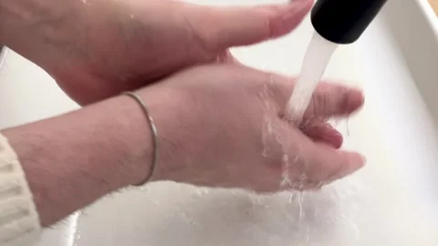 Washing hands under running water close-up hygiene routine Stock Footage 334042274