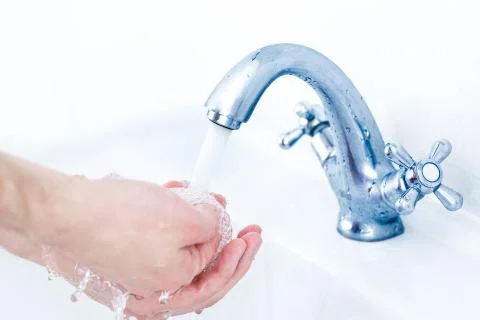 Washing hands under running water tap Foto stock