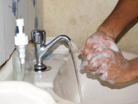 Washing hands by using soap and water Stock Photos