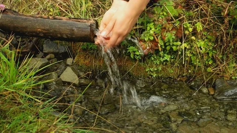 Washing hands with water from a mountain spring Stock Footage 83150204