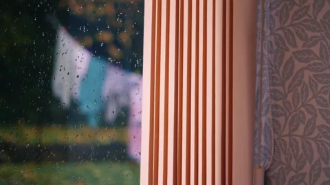 Washing hung out on line in rainfall Stock Footage 255235126
