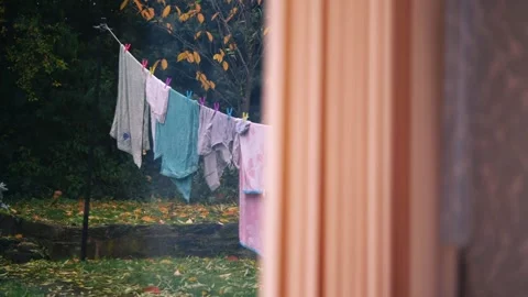 Washing hung out on line view through window Stock Footage 255558722