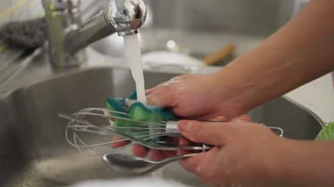 Washing Kitchen Utensils Under the Refreshingly Clean Running Water of the Sink Stock Footage 308822193