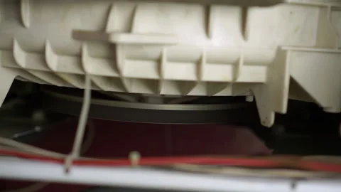 Washing laundry machine drum rotates belt spinning vibration malfunction repair Video stock 130473860