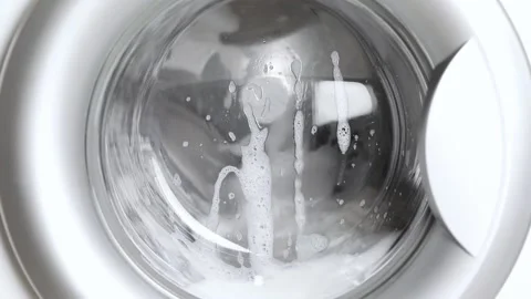 Washing light colored clothes in the washing machine Stock Footage 229429318