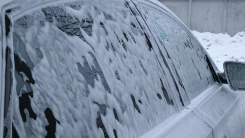 Washing luxury silver car on touchless car wash. Washing sedan car with foam Stock Footage 250595884