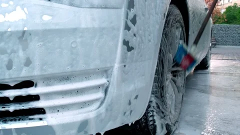 Washing luxury silver car on touchless car wash. Washing sedan car with foam Stock Footage 252054770