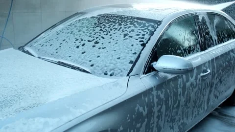Washing luxury silver car on touchless car wash. Washing sedan car with foam Stock Footage 255006688