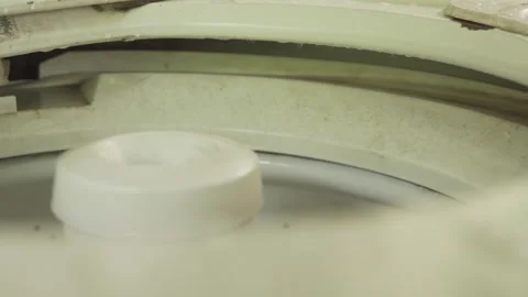 Washing machine agitator spinning inside laundry drum Stock Footage 320968174