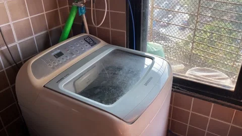 A washing machine beside a window Stock Footage 228048858