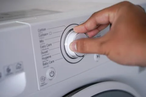Washing machine Choosing Program On Washing Machine Stock Photos