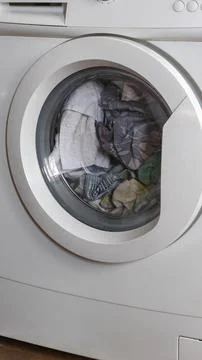 Washing machine with clothes inside drum, Fotos Stock