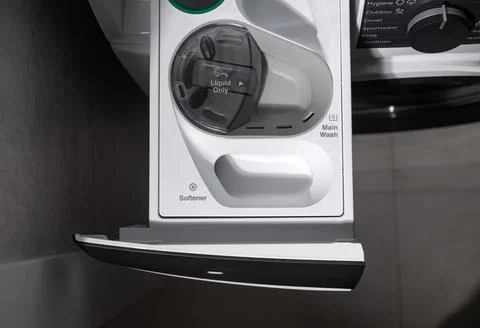 Washing machine detergent drawer pulled out from appliance. Household laundry Stock Photos