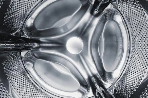 Washing machine drum inside, silver-colored steel background Stock-Fotos