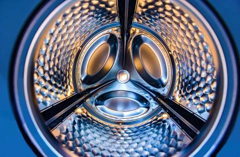 Washing machine drum interior. Perspective inside view into blue washing mach Stock Photos