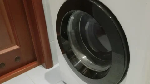 Washing machine drum rotating during wash cycle close up Video stock 341559686