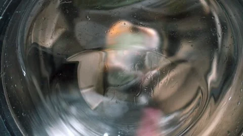 Washing machine drum spinning with clothes Stock Footage 323949960
