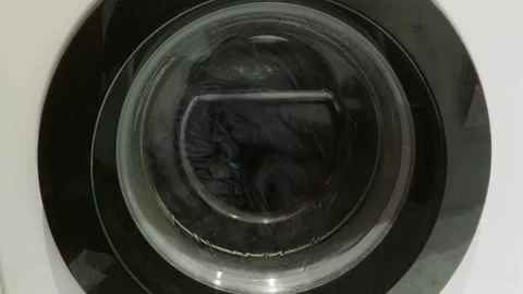 Washing machine drum spinning during laundry cycle close up Video stock 341559745