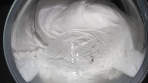 Washing machine drum spinning white clothes 스톡 동영상 329583771