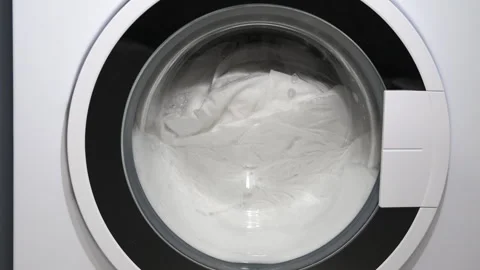 Washing machine drum spinning with white laundry Stock-Footage 331796783