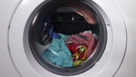 Washing machine drum while washing clothes Stock Footage 258734993