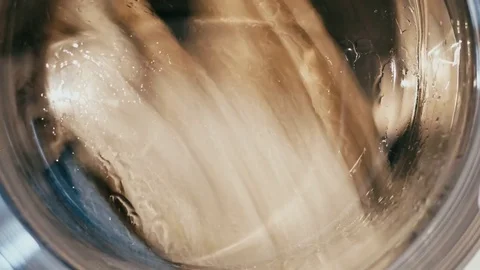 Washing machine filled with clothes closeup macro shot Video stock 73914604