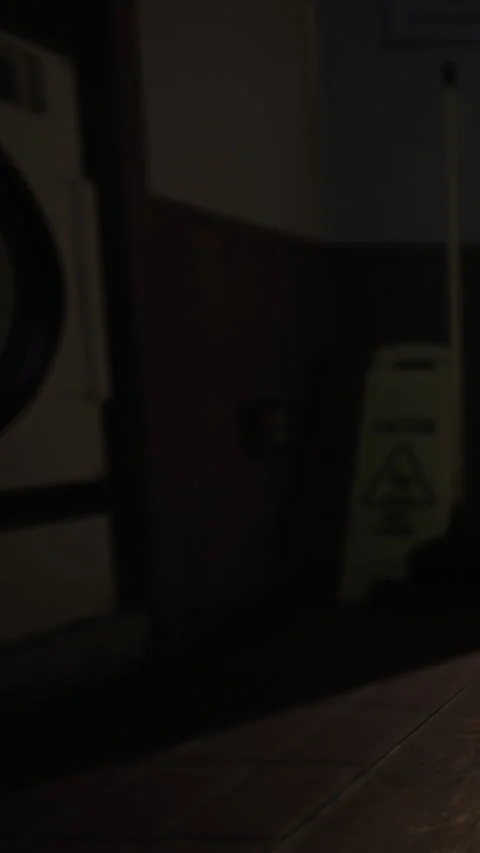 Washing machine in a laundry room with the door slightly open Stock Footage 337972166
