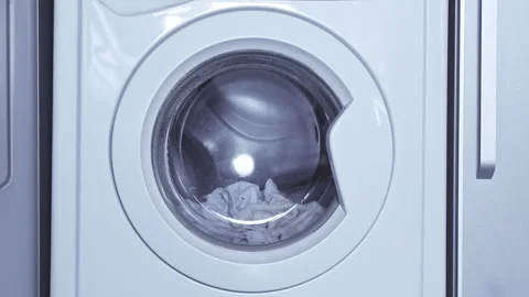 Washing machine in operation, washing light clothes, drum rotating, household Stock Footage 316044966