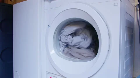 Washing machine or dryer with grey bed linen Video stock 154763776