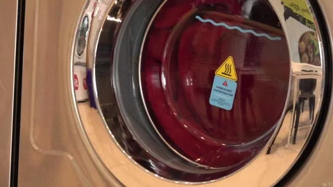 A washing machine with a red plate on it Stock Footage 289316301