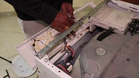Washing machine repairing by a working professional expert man. Stock Footage 228397876