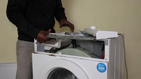 Washing machine repairing by a working professional expert man. Stock Footage 228397882