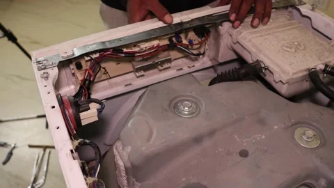 Washing machine repairing by a working professional expert man. Stock Footage 228397919