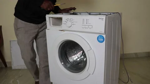Washing machine repairing by a working professional expert man. Stock Footage 228397934