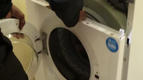 Washing machine repairing by a working professional expert man. Stock Footage 228397967